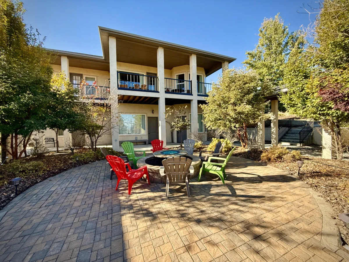 The image captures a welcoming outdoor fire pit surrounded by colorful chairs on a balcony, set against the backdrop of the casita. The scene suggests opportunities for social gatherings, relaxation, and enjoying the evening ambiance under the stars.